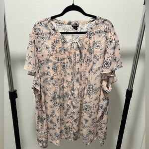 Torrid, Pink with Black Flowers blouse. It is a Size 5. It is sheer.